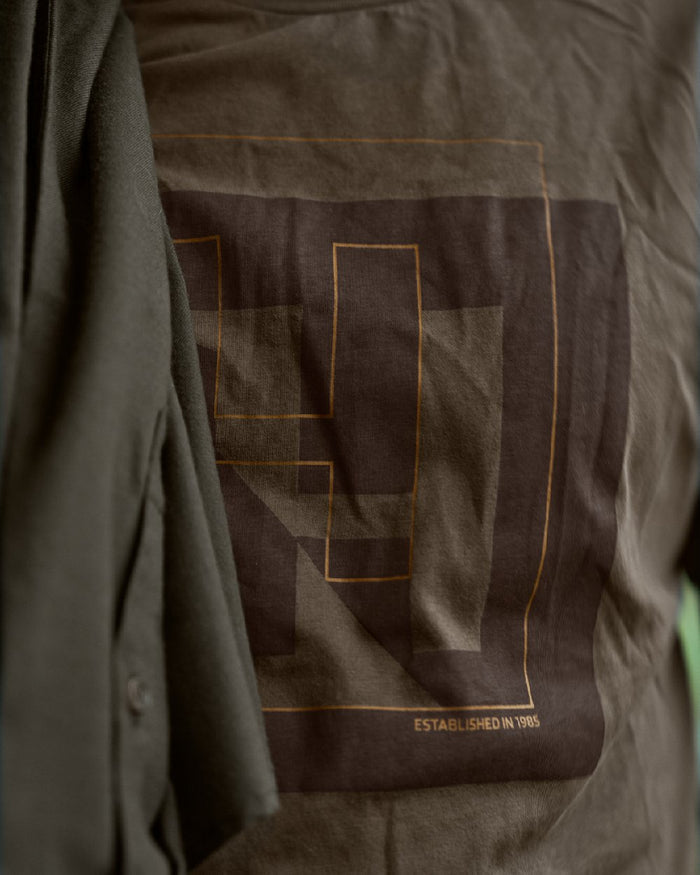 Major Brown Coloured Harkila Mens H-logo Short Sleeve T-Shirt on blurry background #colour_major-brown