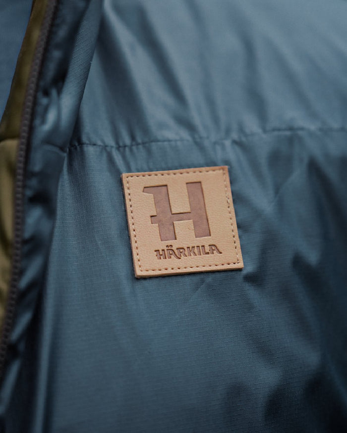 Willow Green Sea Blue Coloured Harkila Mens Kalix HSP Jacket on blurry background #colour_willow-green-sea-blue