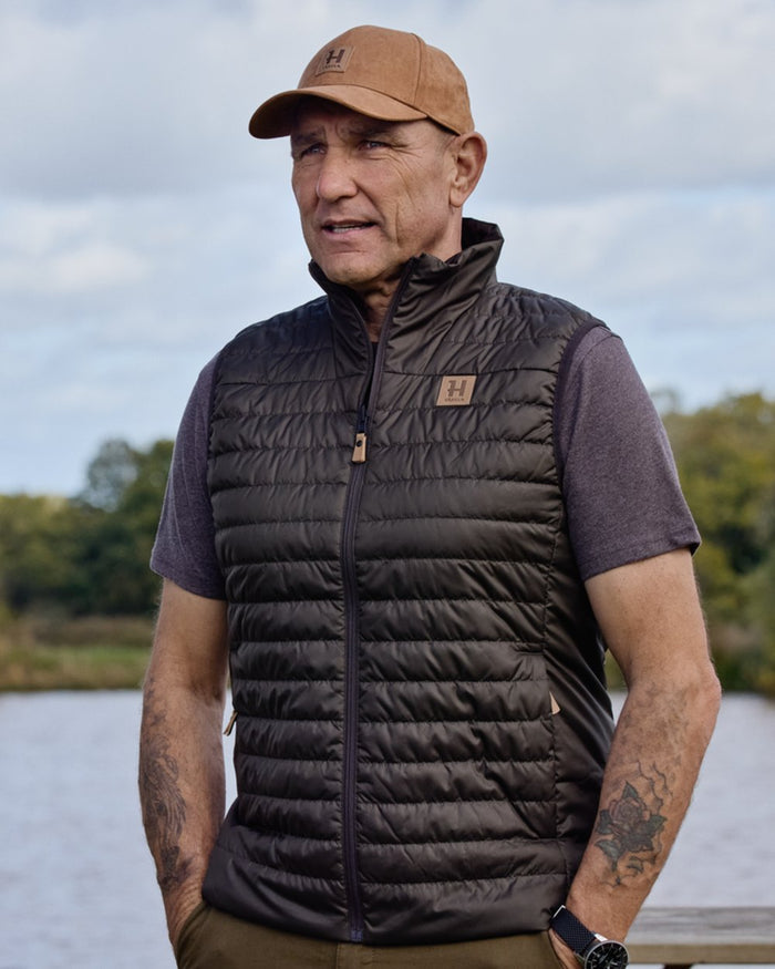 Willow Green Shadow Brown coloured Harkila Mens Kalix HSP Waistcoat on outdoor background #colour_willow-green-shadow-brown