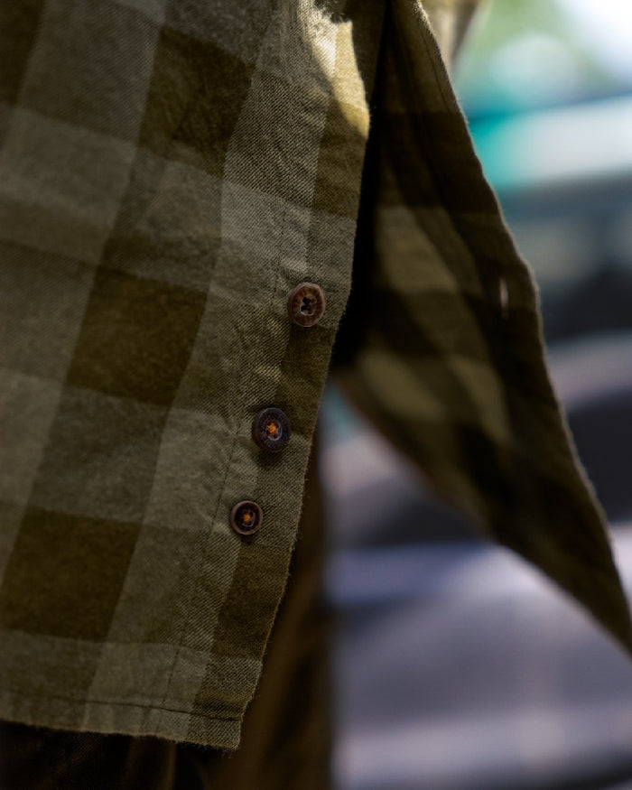 Dark Olive Check Coloured Harkila Scandinavian Long Sleeve Shirt on blurry background #colour_dark-olive-check