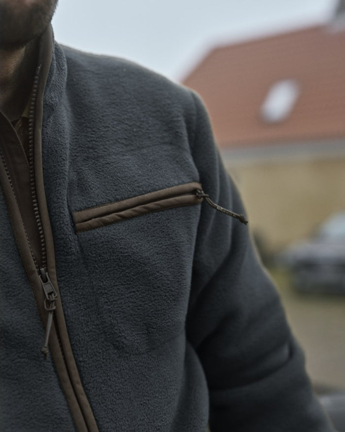 Dark Navy Coloured Harkila Torsby Fleece Jacket on outdoor background #colour_dark-navy