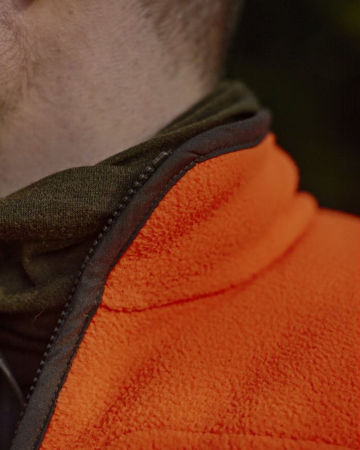 Orange Blaze Coloured Harkila Wildboar Pro Blaze Fleece Jacket on forest background #colour_orange-blaze