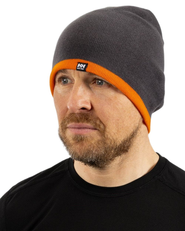 Dark Grey Orange coloured Helly Hansen Classic Reversible Beanie on white background #colour_dark-grey-orange
