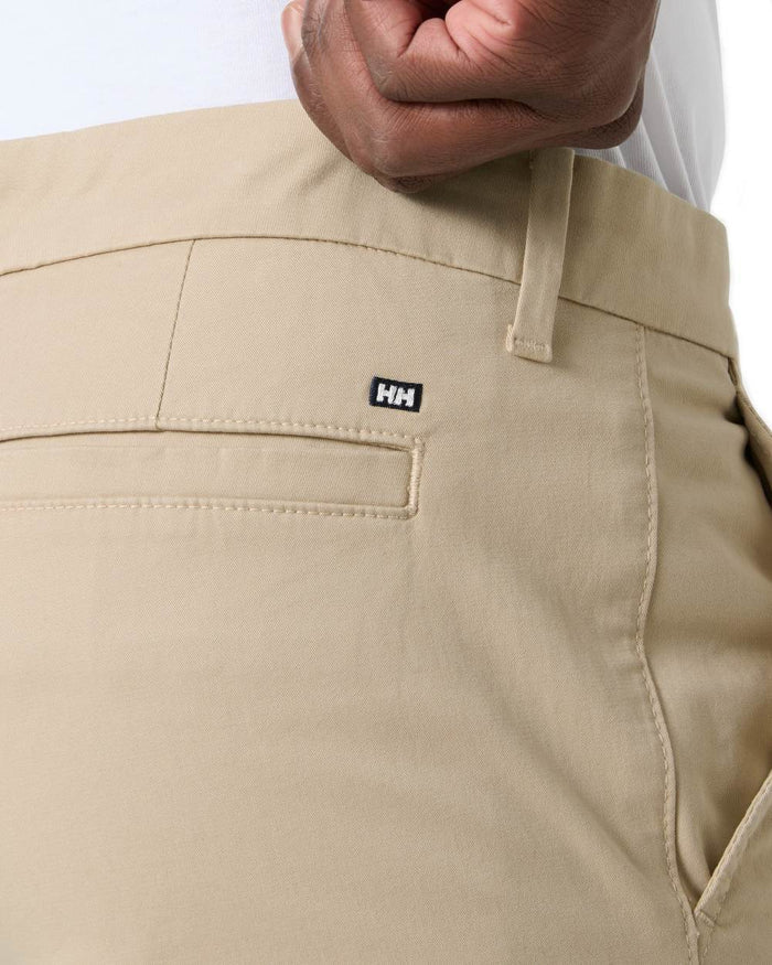 Khaki coloured Helly Hansen Mens Bryggen Chino Shorts on white background #colour_khaki