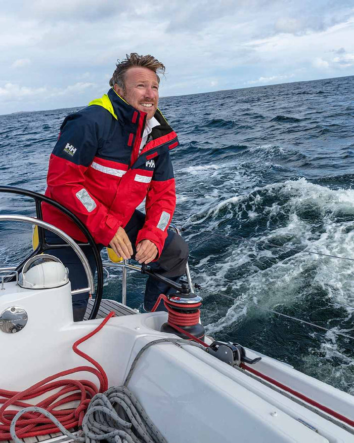 Red coloured Helly Hansen Mens Pier 4.0 Jacket on sea background #colour_red