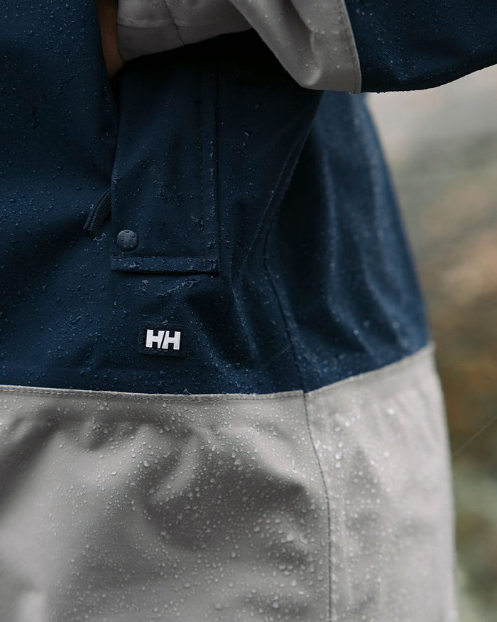 White coloured Helly Hansen Womens Koster Raincoat on blurry background #colour_white
