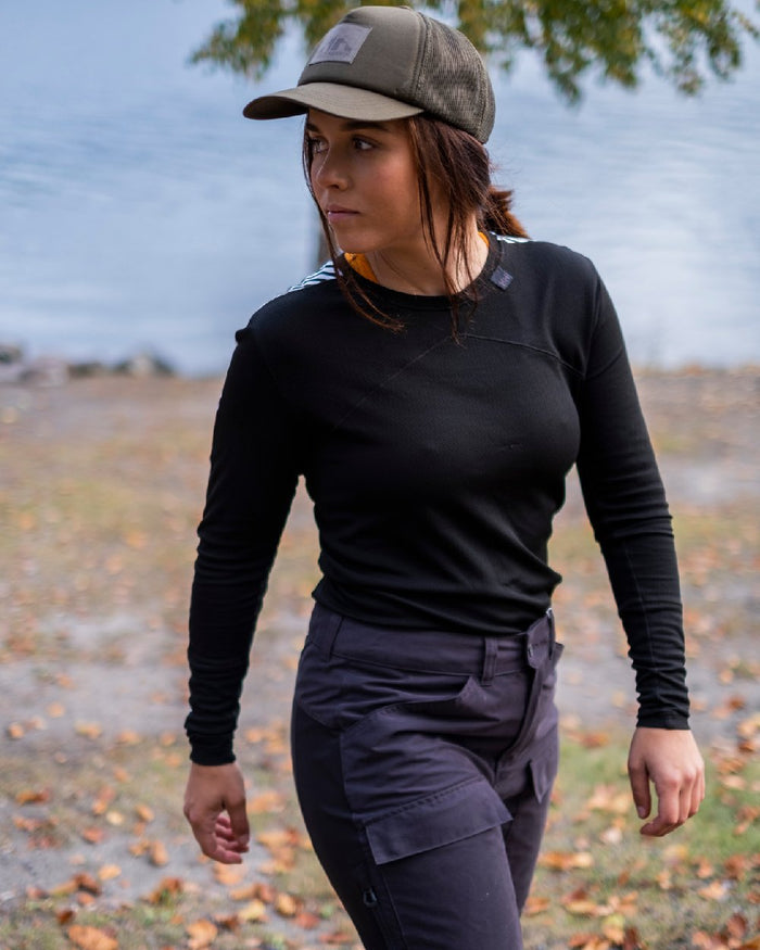 Black Coloured Helly Hansen Womens Lifa Long Sleeve Crew Base Layer on blurry background #colour_black