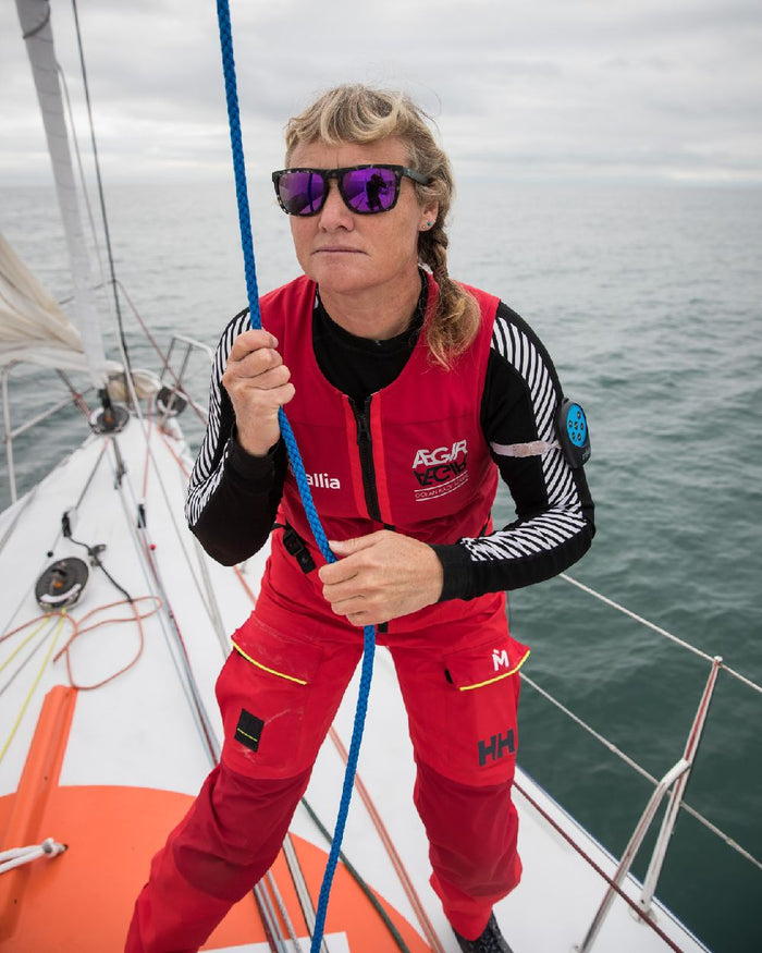 Black Coloured Helly Hansen Womens Lifa Long Sleeve Crew Base Layer on sea background #colour_black