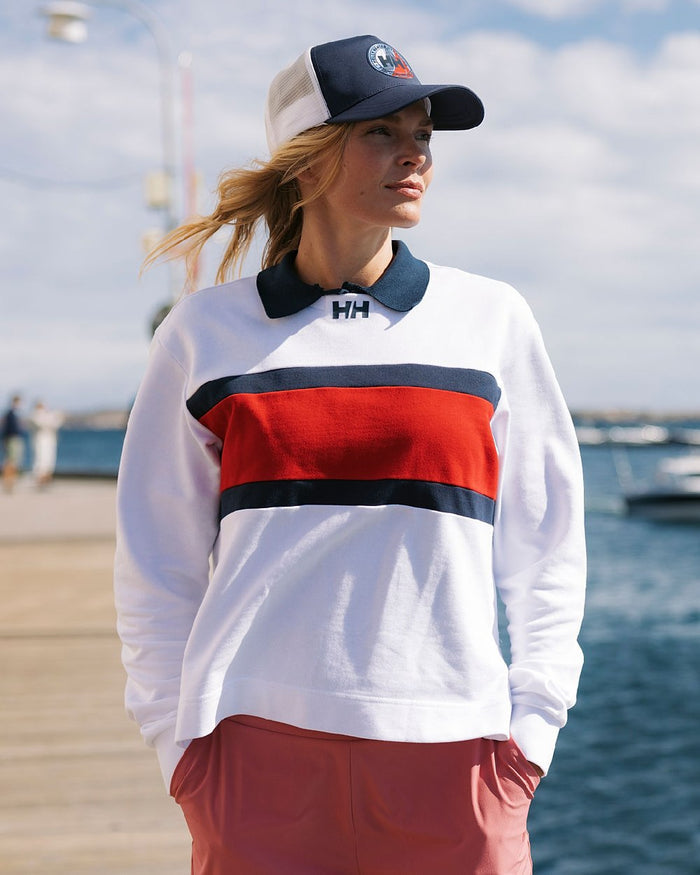 White coloured Helly Hansen Womens Salt Crew Sweatshirt on blurry background #colour_white