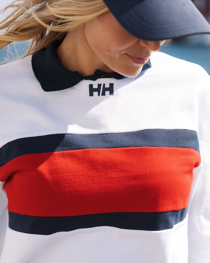 White coloured Helly Hansen Womens Salt Crew Sweatshirt on blurry background #colour_white