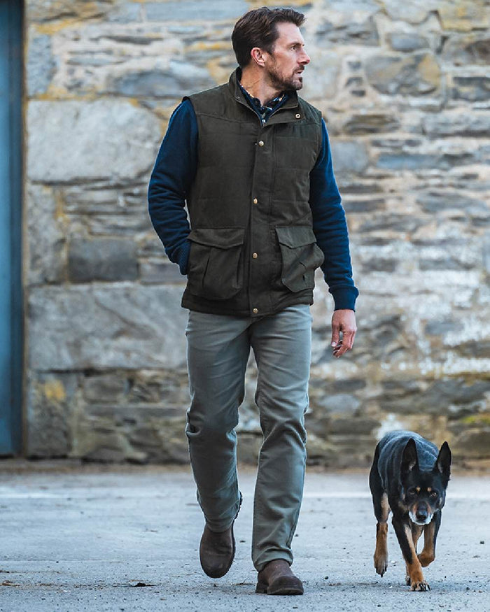 Loden coloured Hoggs of Fife Mens Glenbervie Quilted Gilet on wall background #colour_loden