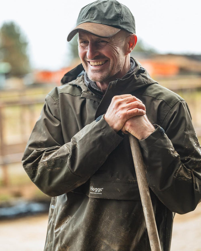 Green Coloured Hoggs of Fife Green King II Waterproof Smock on blurry background #colour_green