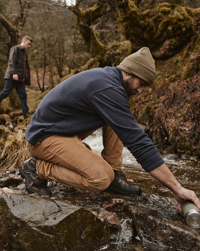 Olive coloured Hoggs of Fife Knitted Thinsulate Waterproof Beanie on mountain background #colour_olive