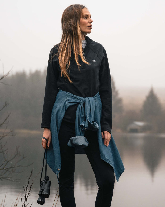 Black coloured Hoggs of Fife Ladies Skye Active Quarter Zip Top on lake background #colour_black