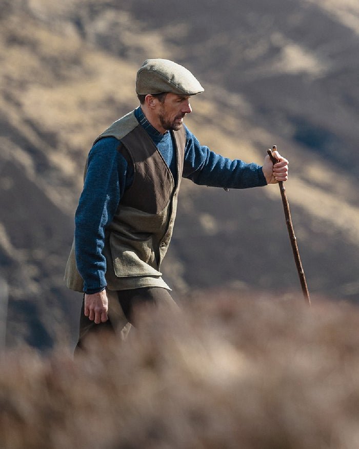 Storm Blue coloured Hoggs of Fife Melrose II Crew Pullover on blurry background #colour_storm-blue