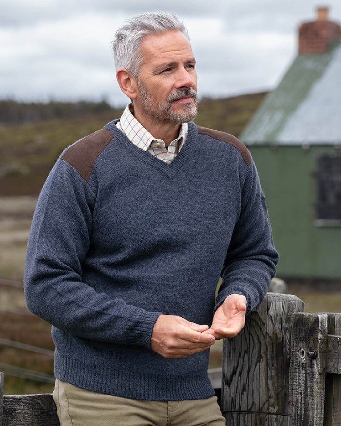 Storm Blue coloured Hoggs of Fife Melrose II V Neck Pullover on countryside background #colour_storm-blue
