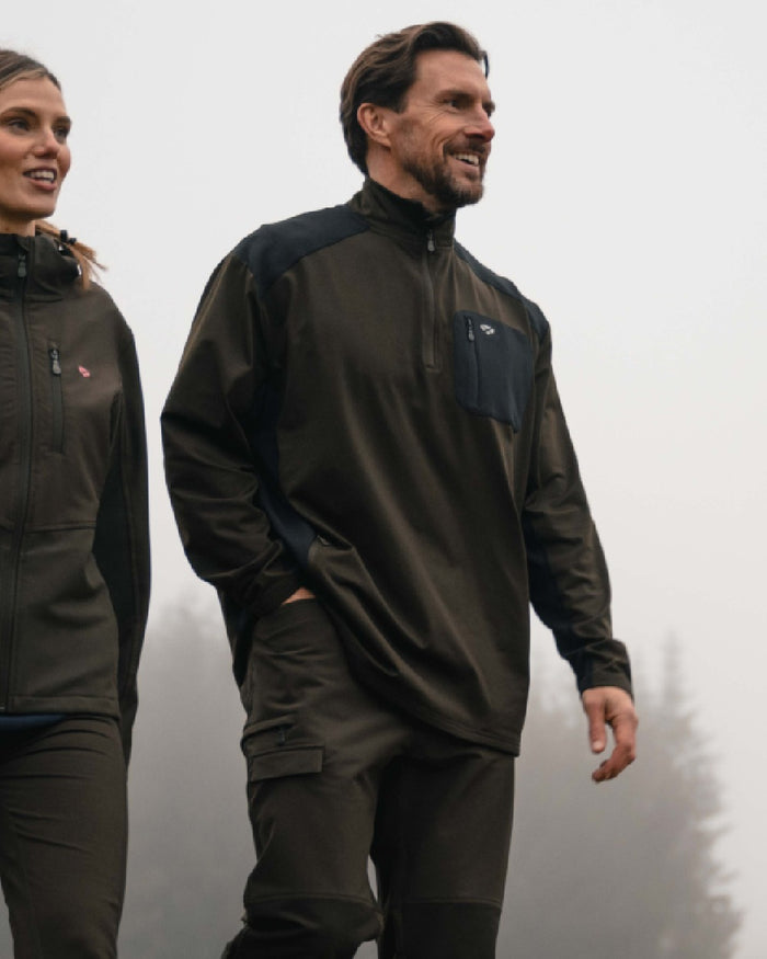 Green Black coloured Hoggs of Fife Mens Barra Active Quarter Zip Top on outdoor background #colour_green-black