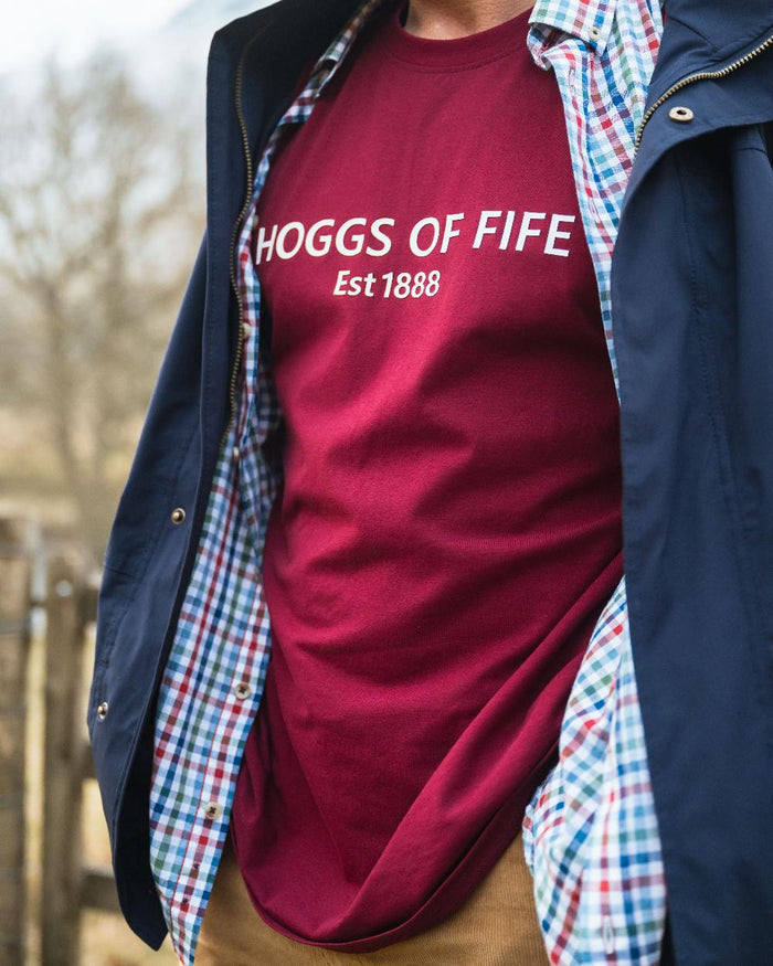 Burgundy Coloured Hoggs of Fife Mens Canonbie Printed T-Shirt on blurry background #colour_burgundy
