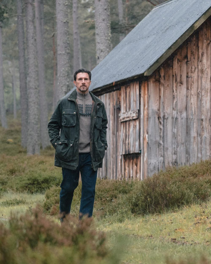 Oatmeal coloured Hoggs of Fife Mens Colonsay Fair Isle Quarter Zip Pullover on forest background #colour_oatmeal