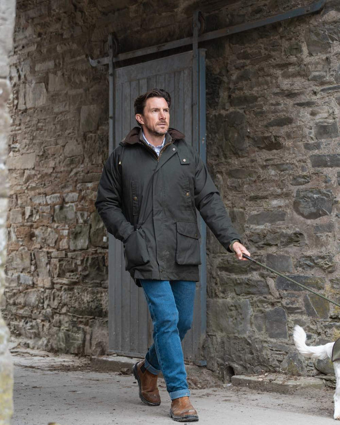 Forest Green Coloured Hoggs of Fife Mens Kelso Waterproof Wax Jacket on outdoor background #colour_forest-green