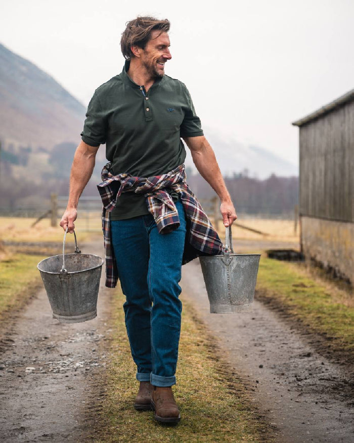 Forest Coloured Hoggs of Fife Mens Newton Pique Polo Shirt on countryside background #colour_forest