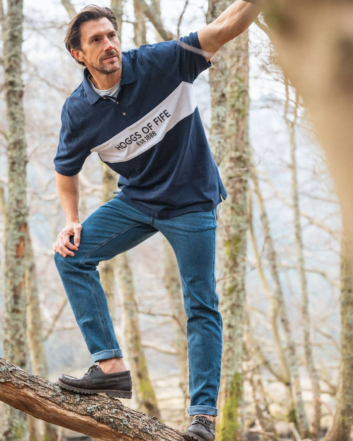Navy Coloured Hoggs of Fife Mens Stewart Block Pique Polo Shirt on forest background #colour_navy