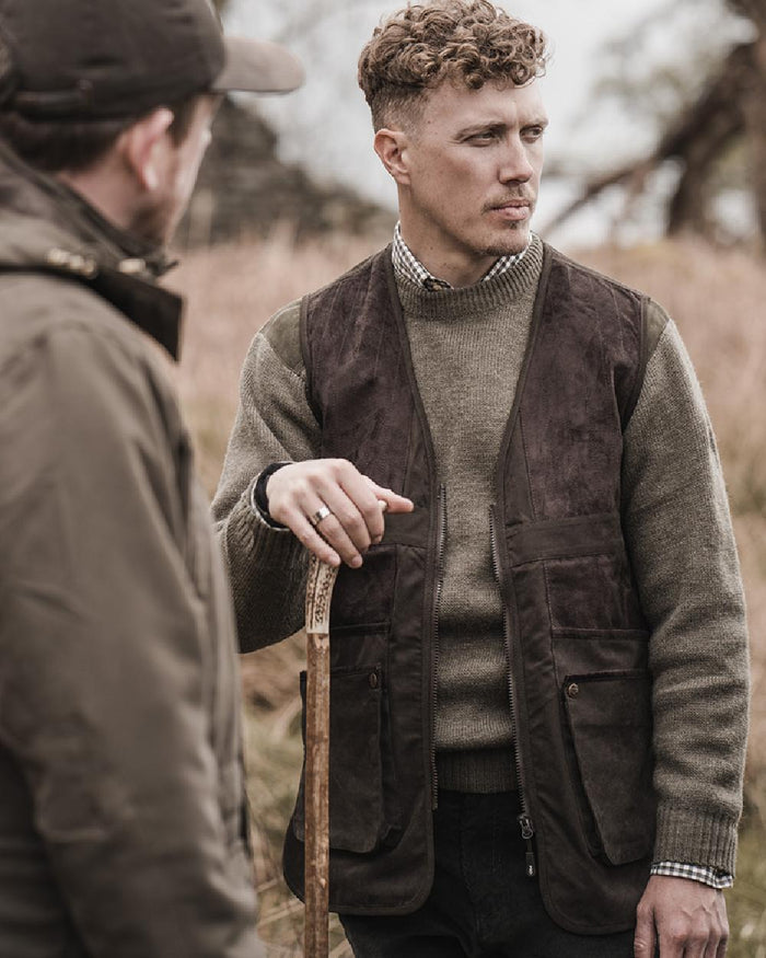 Dark Green coloured Hoggs of Fife Struther Shooting Vest on forest background #colour_dark-green