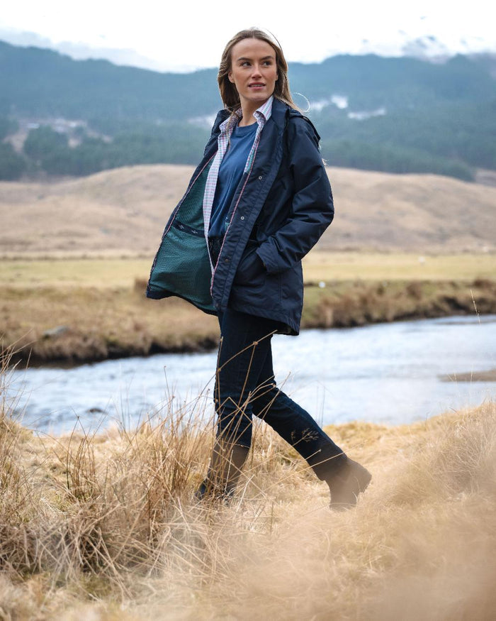 Navy Coloured Hoggs of Fife Womens Fara Waterproof Jacket on countryside background #colour_navy