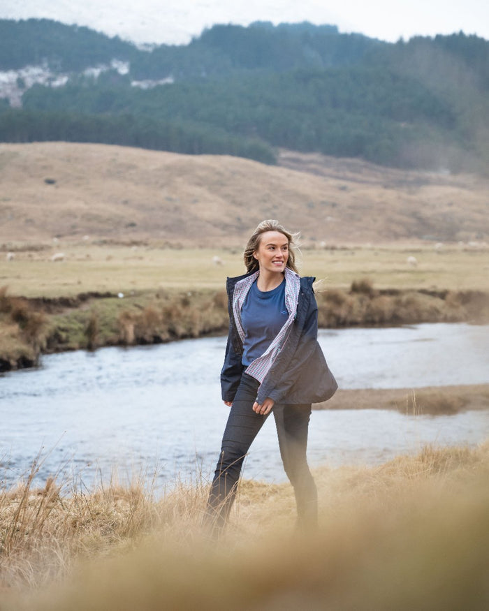 Navy Coloured Hoggs of Fife Womens Fara Waterproof Jacket on countryside background #colour_navy