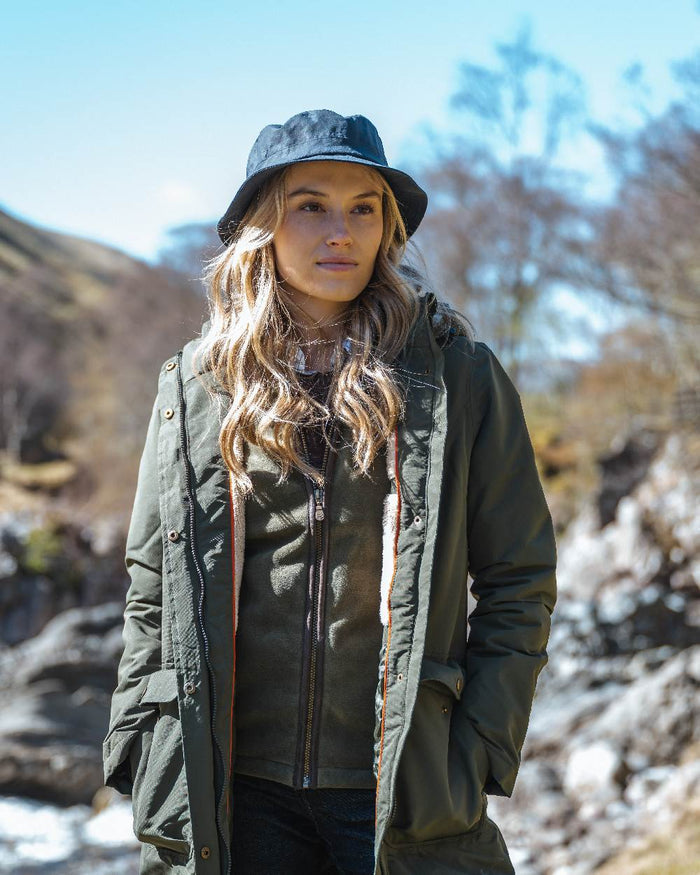 Green coloured Hoggs of Fife Womens Walker Long Coat on mountain background #colour_green