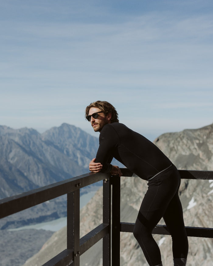 Black Coloured Icebreaker Mens Merino 200 Oasis Crewe Thermal Top on mountain background #colour_black