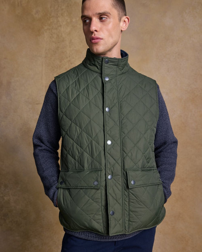 Olive Coloured Jack Murphy Mens Conor Quilted Gilet on indoor background #colour_olive