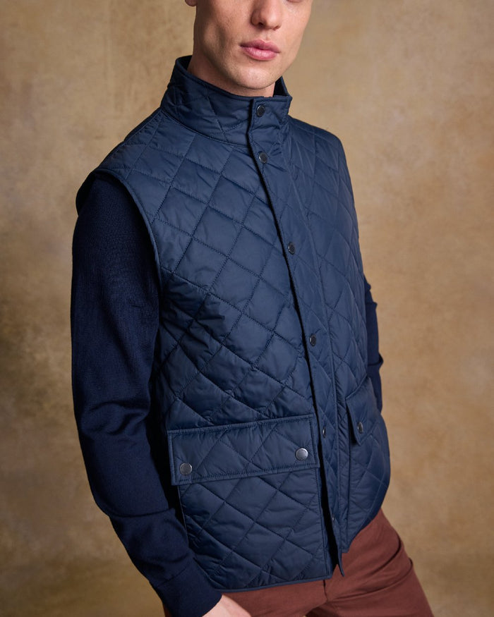 Navy Coloured Jack Murphy Mens Conor Quilted Gilet on indoor background #colour_navy