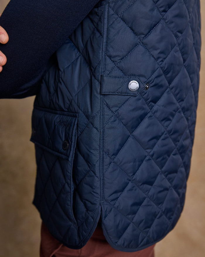 Navy Coloured Jack Murphy Mens Conor Quilted Gilet on indoor background #colour_navy