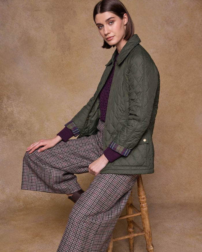 Olive coloured Jack Murphy Womens Molly Quilted Jacket on wall background #colour_olive