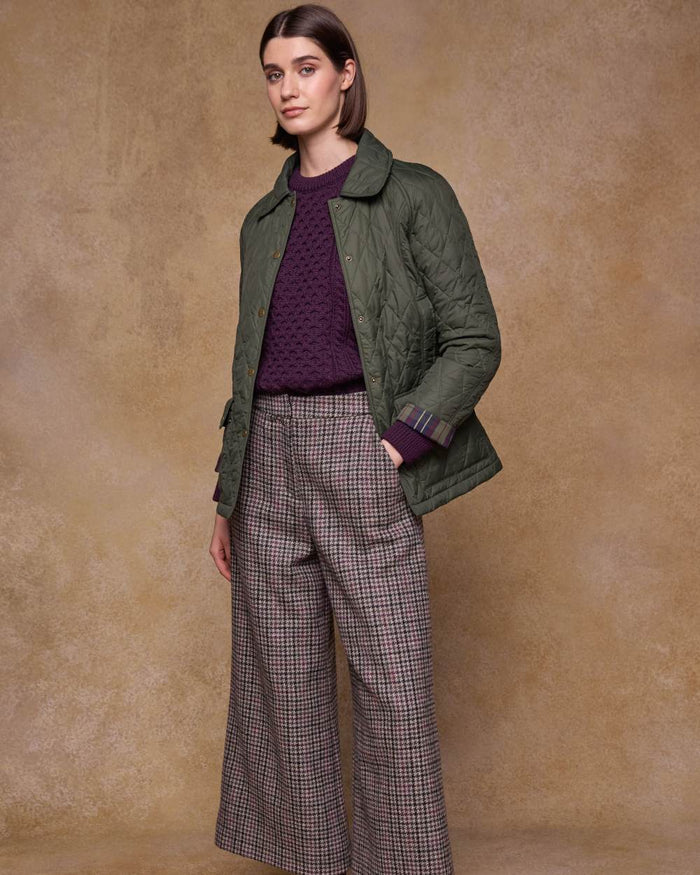 Olive coloured Jack Murphy Womens Molly Quilted Jacket on wall background #colour_olive