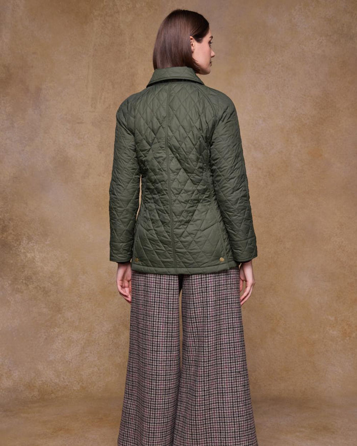 Olive coloured Jack Murphy Womens Molly Quilted Jacket on wall background #colour_olive