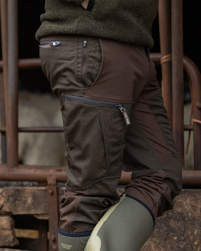 Brown coloured Jack Pyke Technical Hybrid Trousers on outdoor background #colour_brown