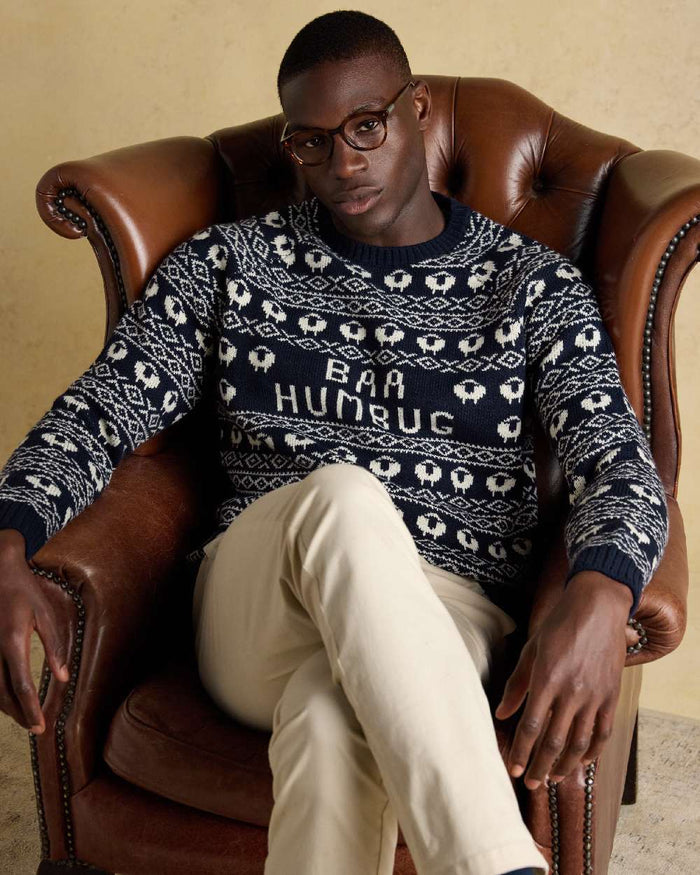 Navy Coloured Joules Mens Baa Humbug Intarsia Christmas Jumper on indoor background #colour_navy