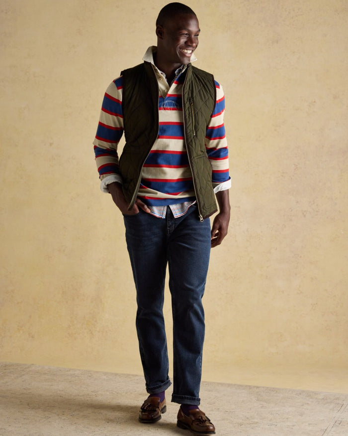 Green coloured Joules Mens Maynard Diamond Quilted Gilet on wall background #colour_green
