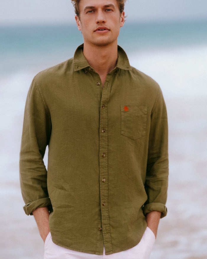 Khaki Green coloured Joules Mens Pure Linen Long Sleeve Classic Fit Shirt on sea background #colour_khaki-green