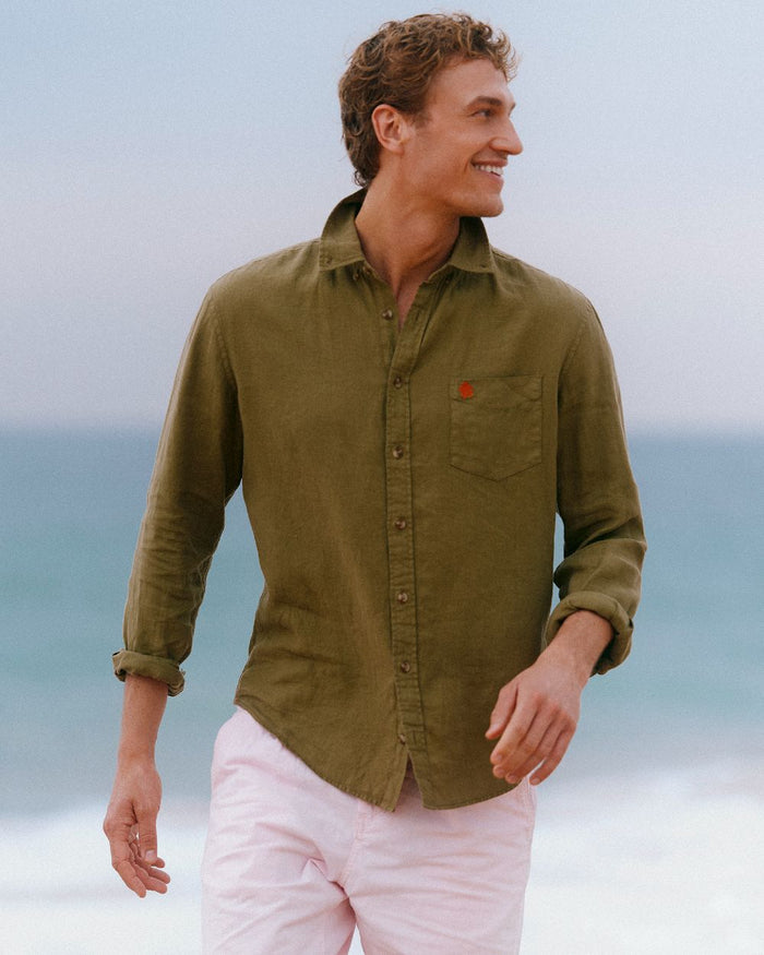 Khaki Green coloured Joules Mens Pure Linen Long Sleeve Classic Fit Shirt on sea background #colour_khaki-green