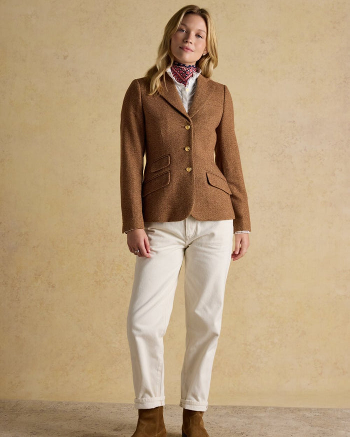Brown Herringbone coloured Joules Womens Canterly Tweed Hacking Jacket on wall background #colour_brown-herringbone