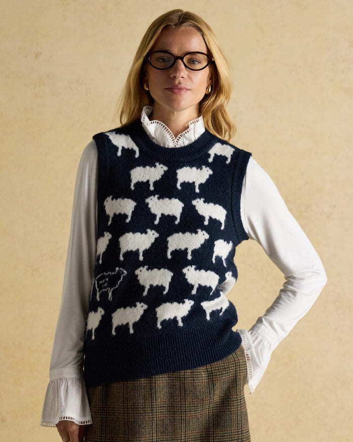Navy coloured Joules Womens What The Flock Intarsia Knitted Vest on wall background #colour_navy