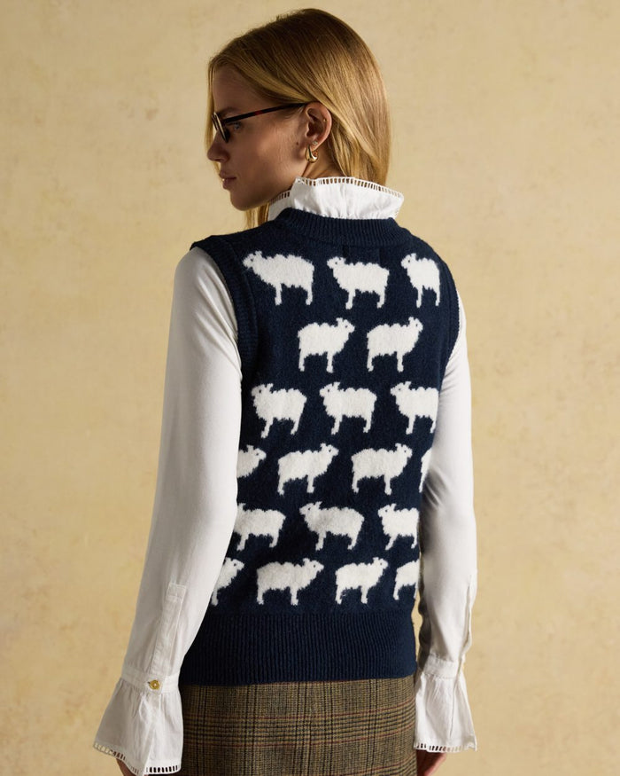 Navy coloured Joules Womens What The Flock Intarsia Knitted Vest on wall background #colour_navy