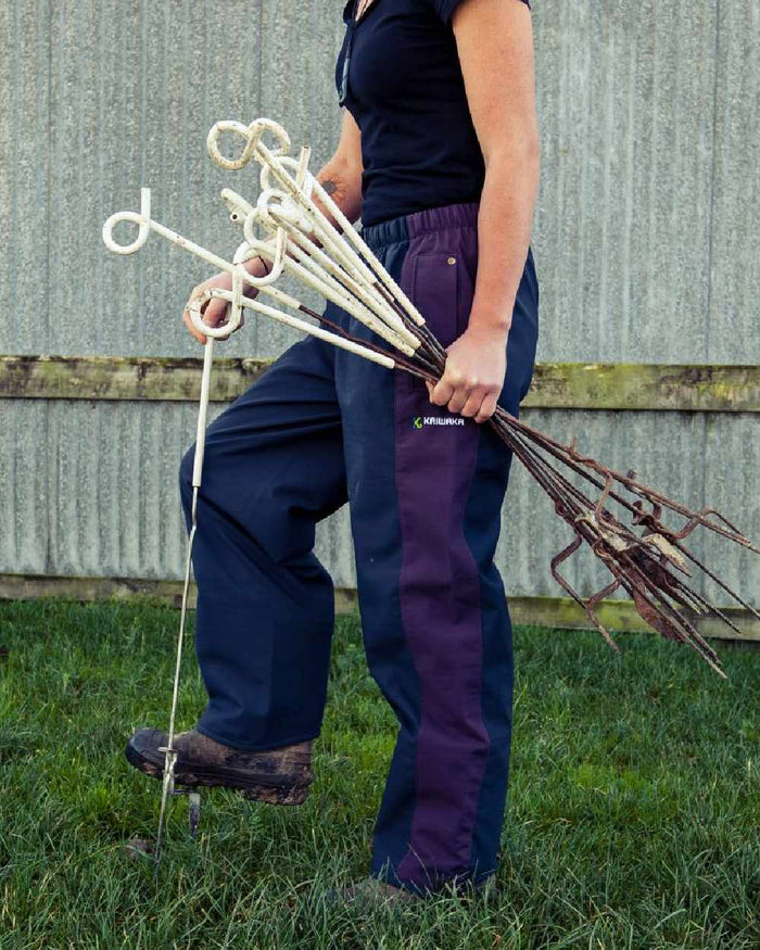 Navy coloured Kaiwaka Womens Stormforce Overtrouser on grassy background #colour_navy