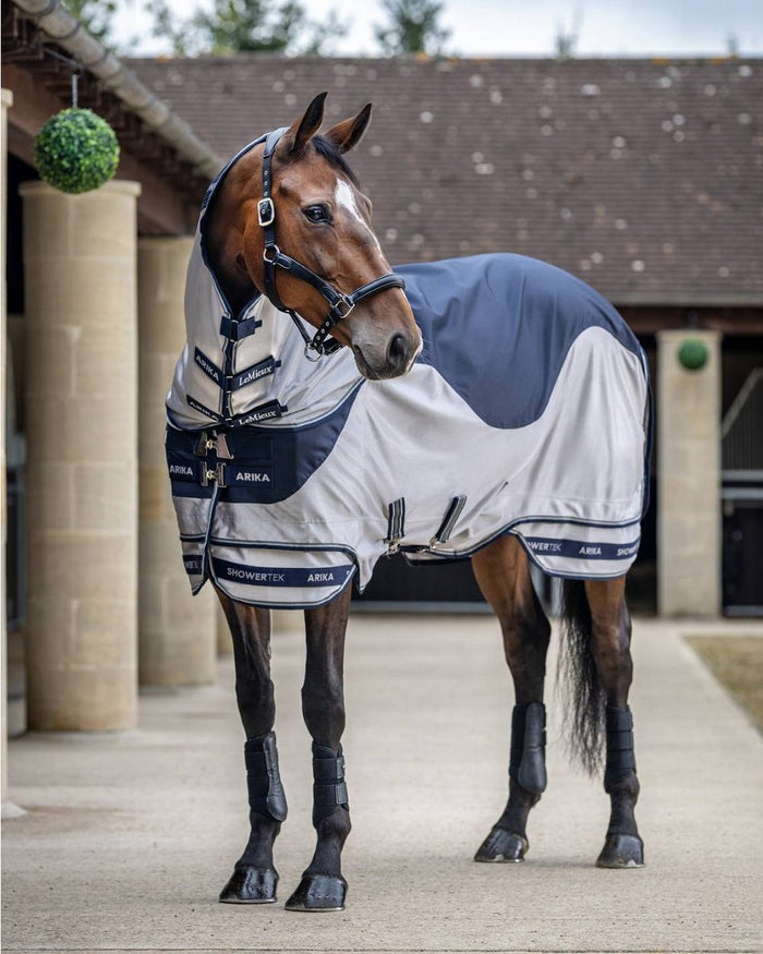 Navy coloured LeMieux Arika Shower Tek Fly Rug on blurry background #colour_navy