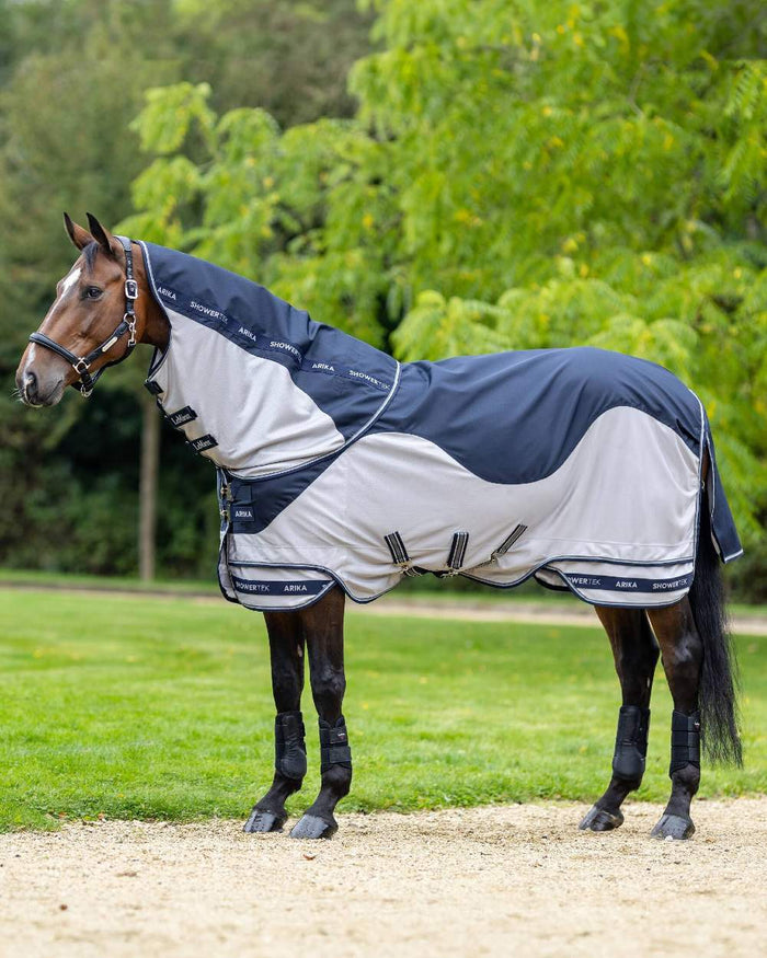Navy coloured LeMieux Arika Shower Tek Fly Rug on blurry background #colour_navy