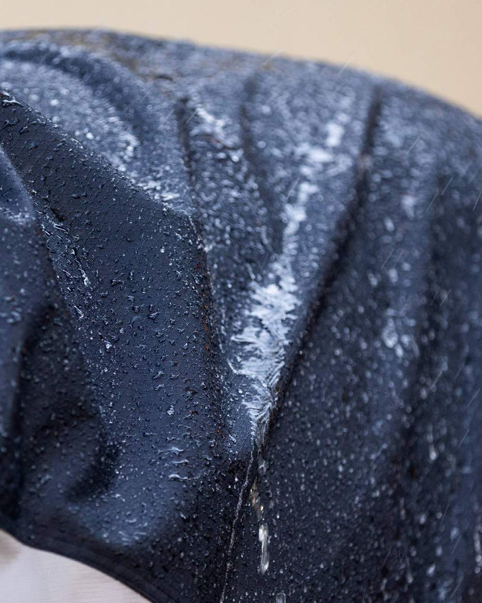 Navy coloured LeMieux Arika Shower Tek Fly Rug on blurry background #colour_navy