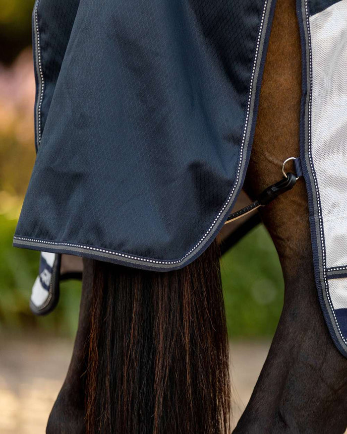 Navy coloured LeMieux Arika Shower Tek Fly Rug on blurry background #colour_navy
